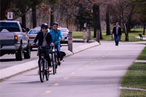 cyclists riding in a bike lane next to the road