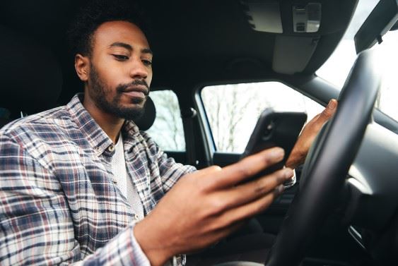 man texting and driving in California