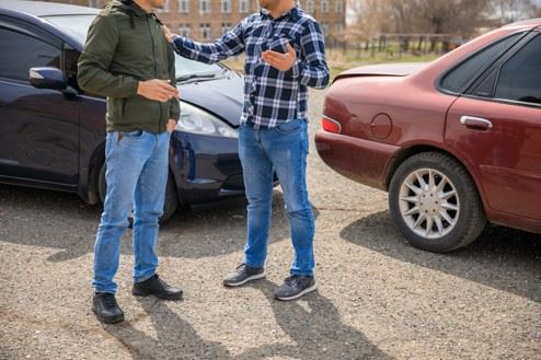 two men arguing after car accident in modesto